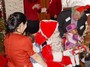 Santa gives a gift to a happy little girl.